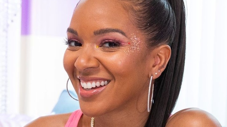 Lizzy Mathis smiling with glitter makeup