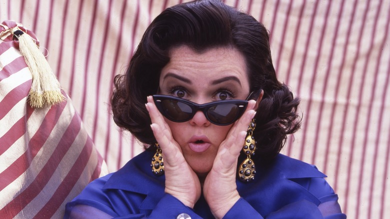 Rosie O'Donnell, posing with a pair of sunglasses in the '90s.