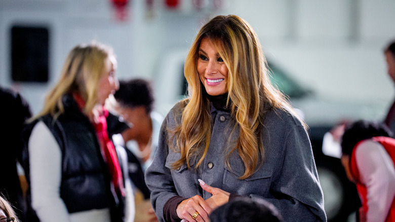 Melania Trump smiling in conversation