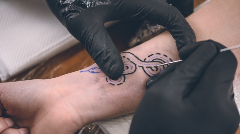 Stick and poke tattoo being done