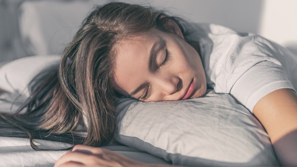 Sunlight shining on sleeping woman