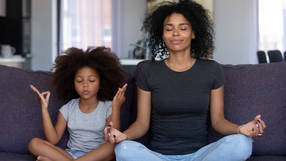 Woman and daughter doing yoga