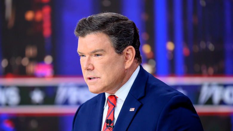 Bret Baier leaning forward while delivering a broadcast