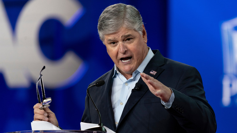 Sean Hannity giving an animated speech at a podium