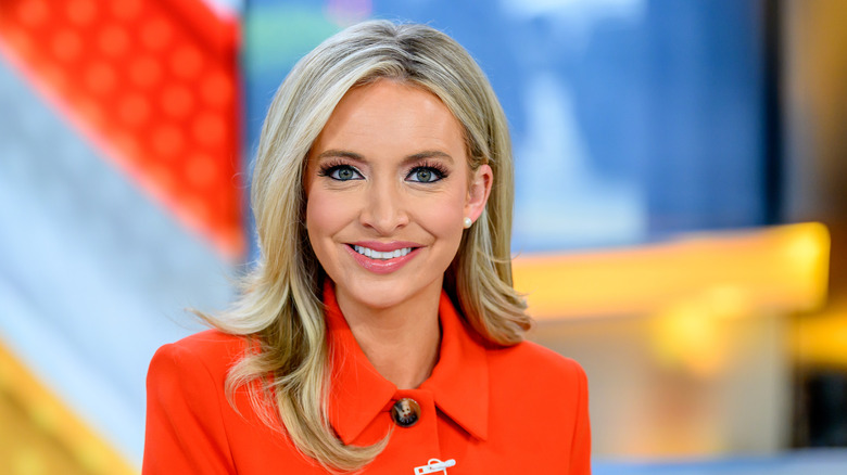 Kayleigh McEnany smiling in a red blazer