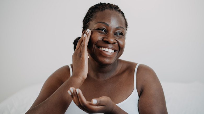 Woman applying sunscreen