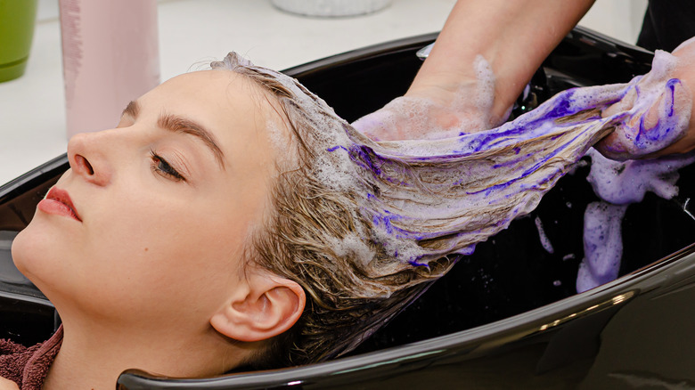 blonde woman getting hair washed