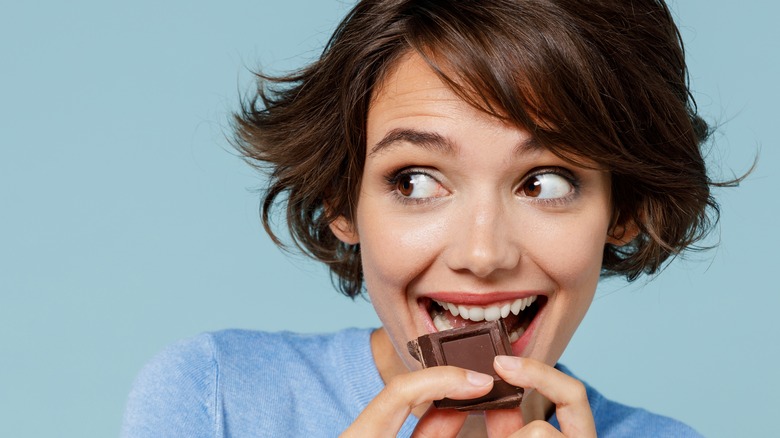A woman eating chocolate 