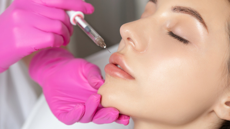 a woman receiving lip filler injections 