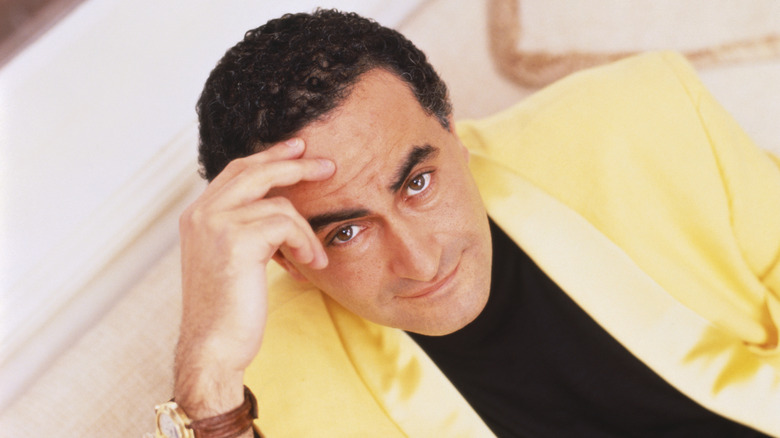 Dodi Fayed with hand on forehead