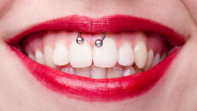 Woman smiling with smiley piercing