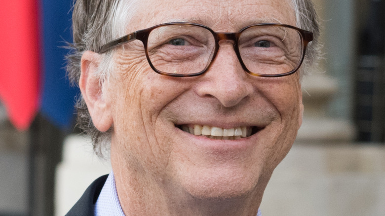 Bill Gates in dark suit with green-striped tie