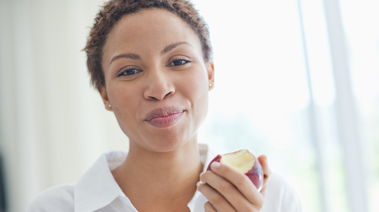 Woman eating apple