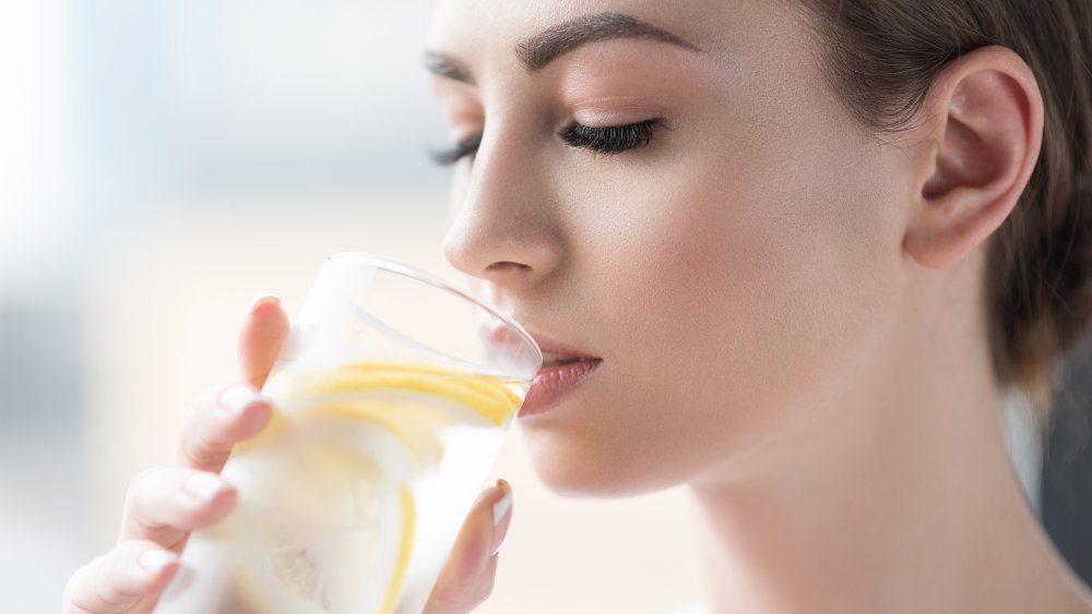 Woman drinking lemon water