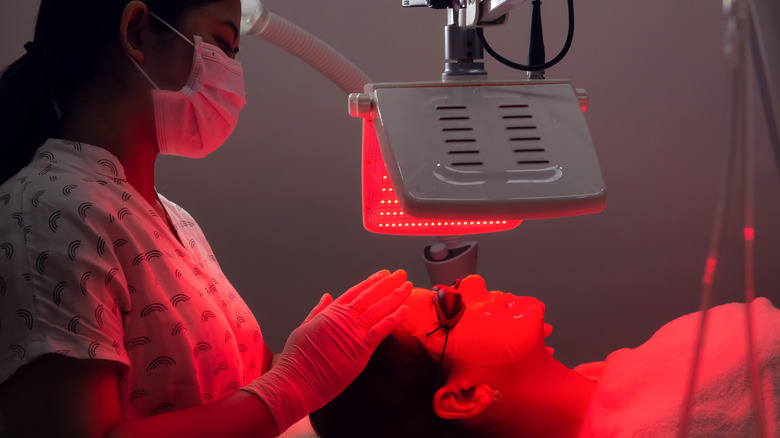 Woman receiving treatment with red light therapy