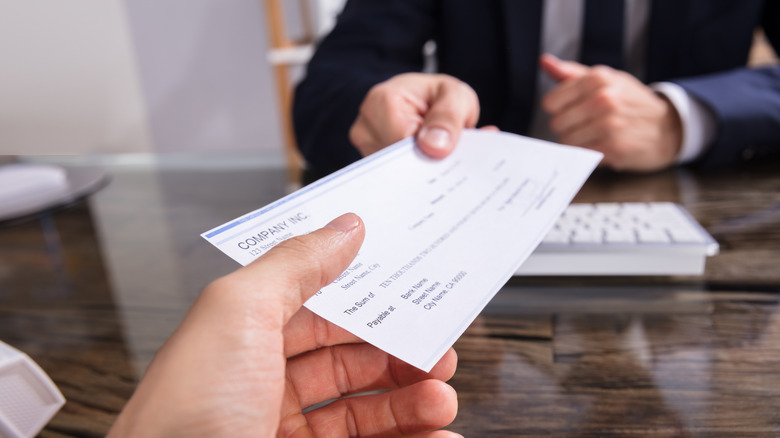 Person receiving a check from businessman