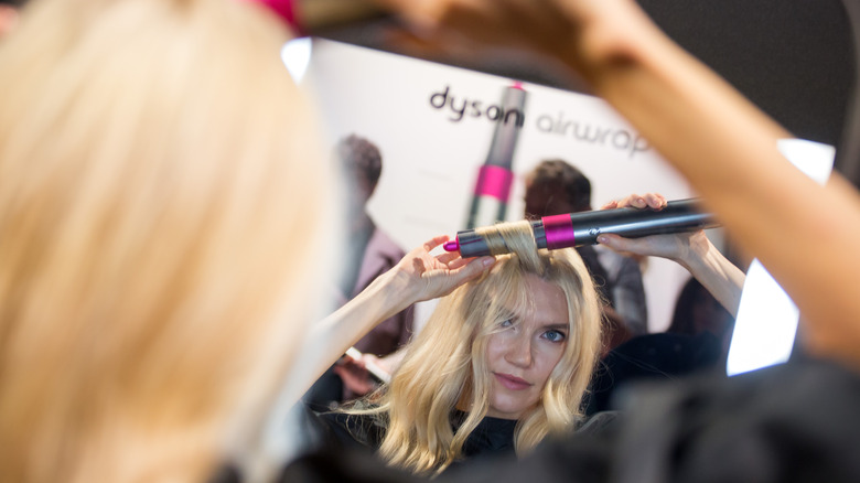 Model using Dyson Airwrap styling tool 