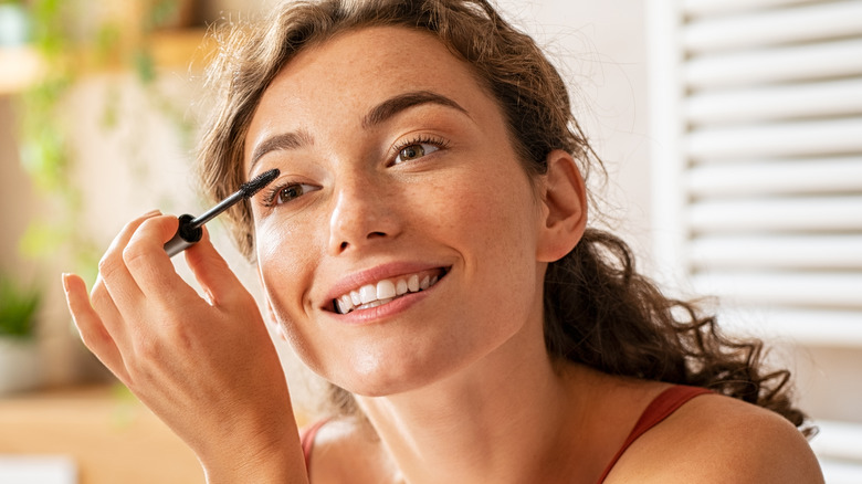 Woman applying mascara 