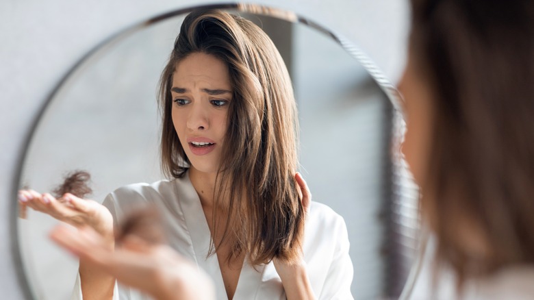 Young woman concerned about hair loss