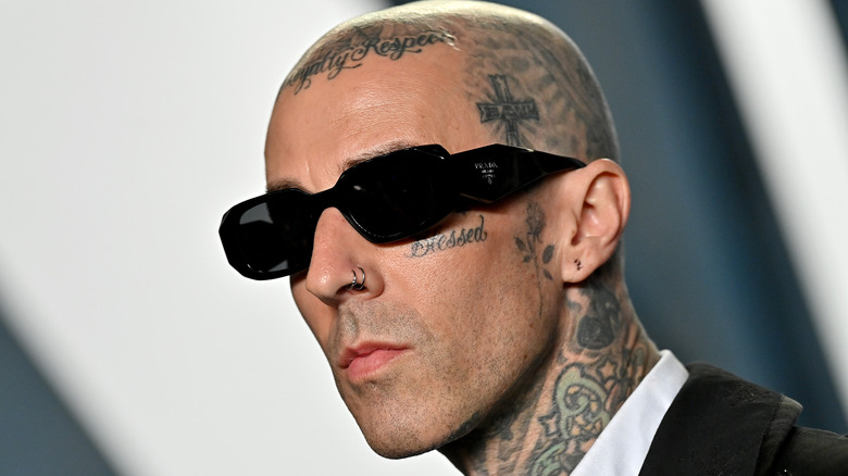 Travis Barker posing on the red carpet 