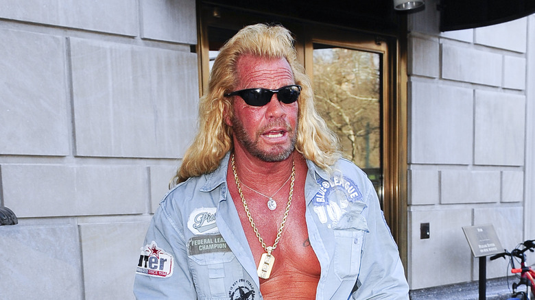 Dog the Bounty Hunter walking on the sidewalk