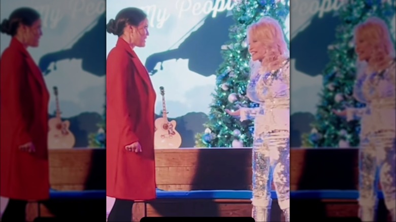 Dolly Parton walking up to Danica McKellar
