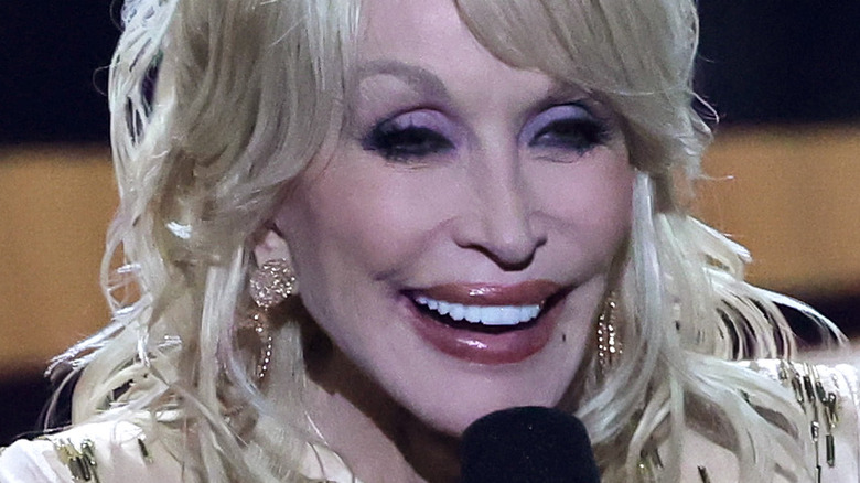 Dolly Parton speaking into microphone