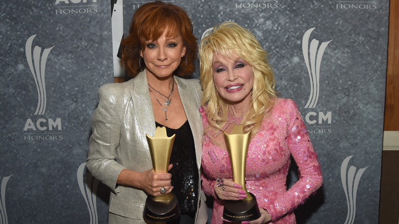Reba McEntire and Dolly Parton holding ACM Honors 2017