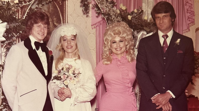 Freida Parton, Dolly Parton, and Carl Dean posing for wedding photos