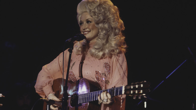 Dolly Parton playing guitar