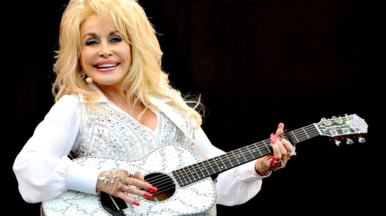 Dolly Parton playing guitar