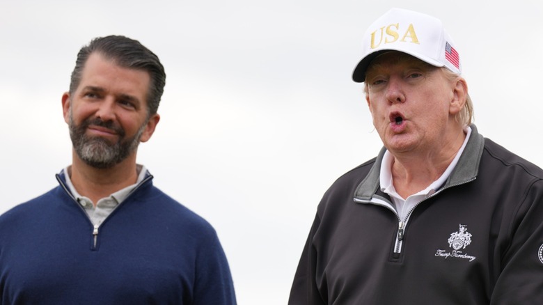 Donald Trump Jr. stands by as Donald Trump speaks at a ribbon-cutting ceremony in Balmedie, Scotland (2025)