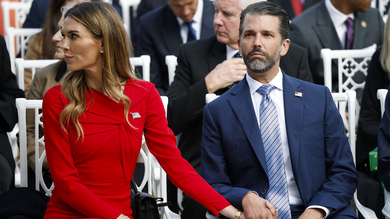 Bettina Anderson in a red dress holding Don Jr.'s hand in a navy suit