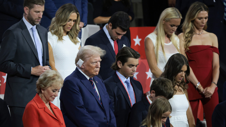 Bettina Anderson (in red) stands with the Trumps at the RNC