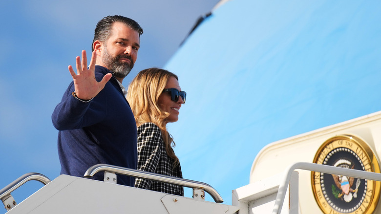 Donald Trump Jr. waving next to Bettina Anderson