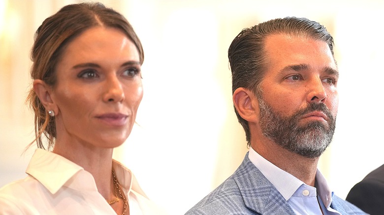 Bettina Anderson and Donald Trump Jr. looking off camera serious