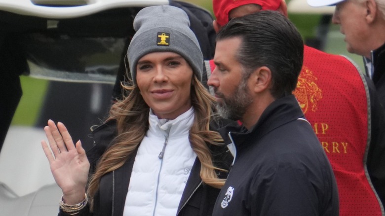Bettina Anderson giving a smile and wave next to Donald Trump Jr.