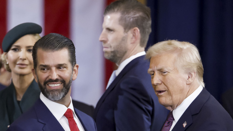 Donald Trump Jr. smiles standing next to Donald Trump