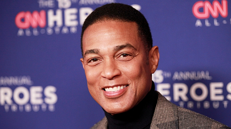 Don Lemon in a gray suit in front of a "CNN Heroes" background