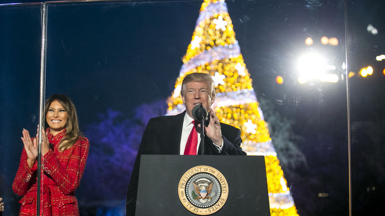 Donald Trump and Melania red coat at outdoor Christmas tree lighting