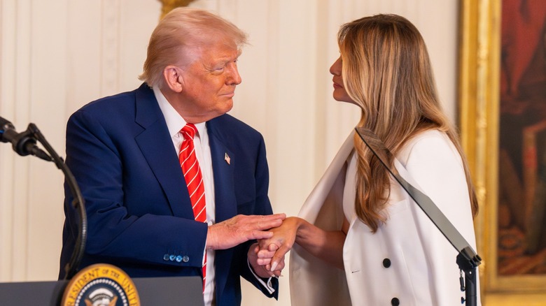 Donald Trump patting Melania Trump's hand