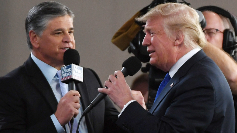 Donald Trump and Sean Hannity holding microphones