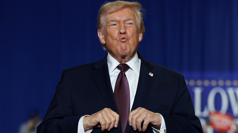 Donald Trump caught in a disturbing pout while wearing a black suit
