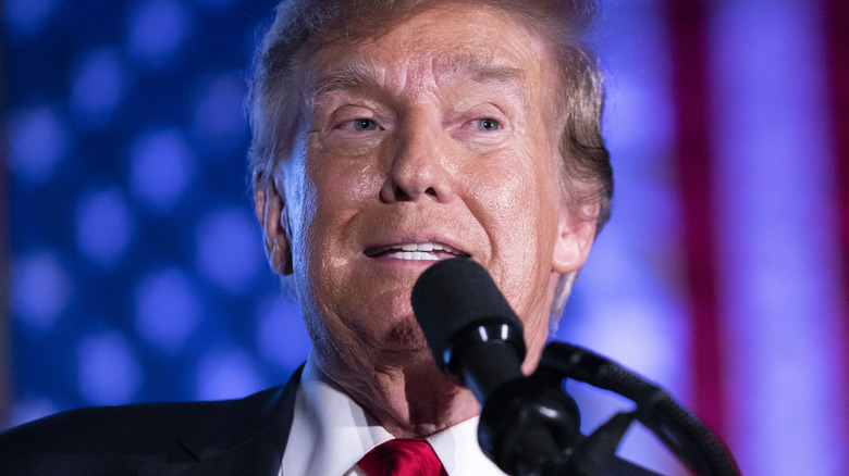 Donald Trump speaking at podium 