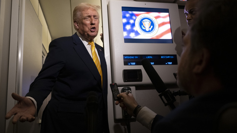 Donald Trump speaks to reporters on Air Force One