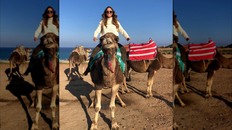 Bettina Anderson rides a camel during a trip to Tangier, Morocco (2019)