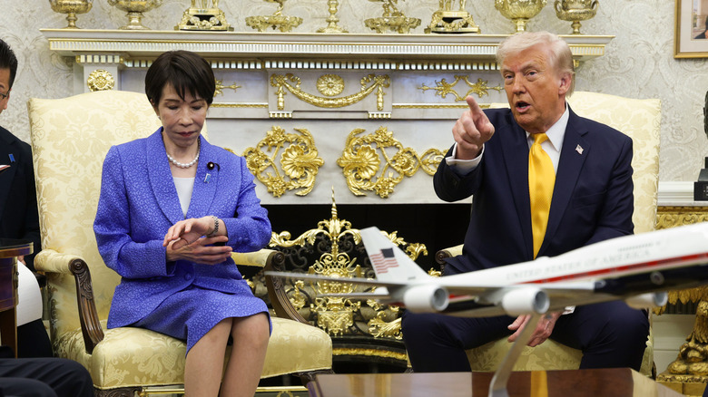 The prime minister of Japan Sanae Takaichi checks her watch sitting next to Donald Trump in the oval office