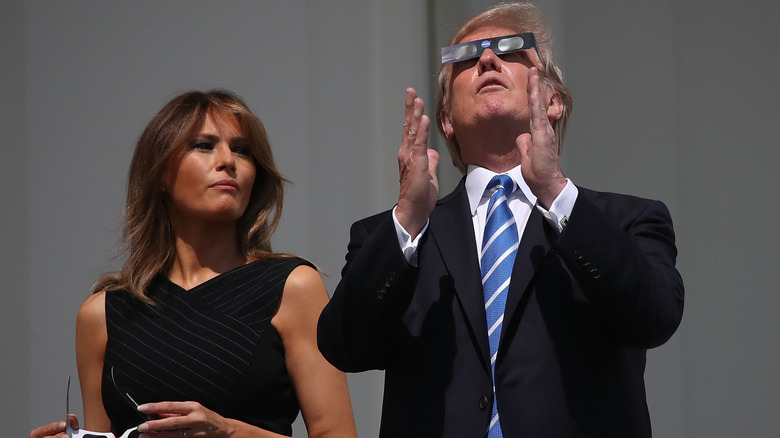 Donald and Melania Trump wearing eclipse glasses