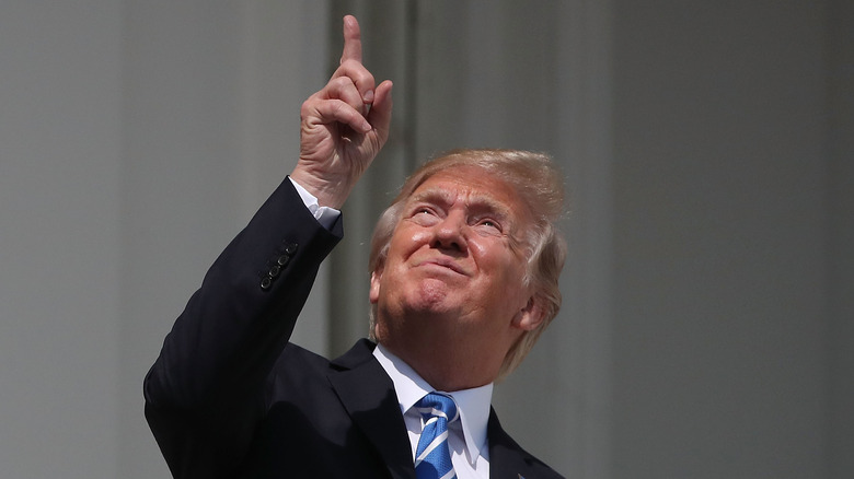 Donald Trump pointing at the solar eclipse in 2017