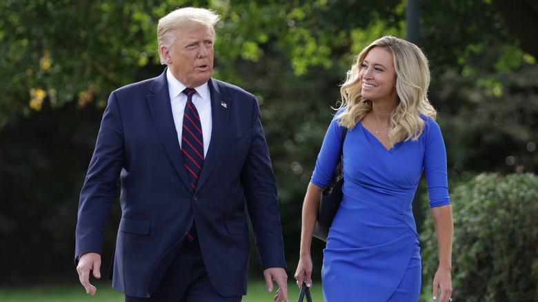 Kayleigh McEnany and Donald Trump walking and talking